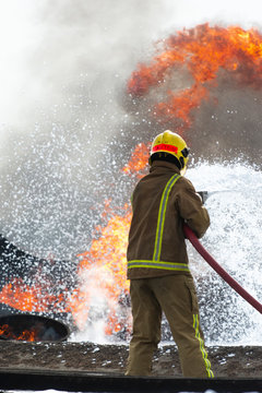 Fire Fighter Battling Blazing Fire - Extinguishing and controlling threat
