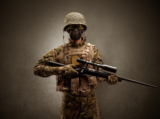 Soldier agent in a dark room with arms on his hand and gas mask
