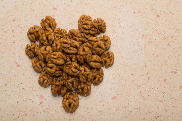 fresh cracked walnut seeds arranged in heart shape