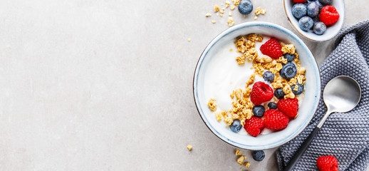 Yogurt with berries and granola in bowl