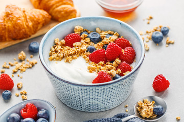 Yogurt with berries and granola in bowl