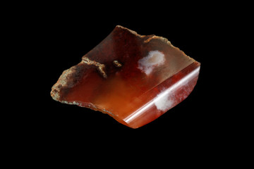 macro stone Carnelian mineral on a black background