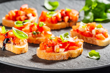 Classic italian bruschetta served on dark plate