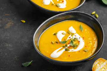 Pumpkin creamy soup served in bowls