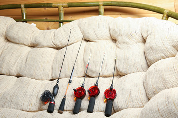 fishing rods for winter fishing on the couch. different fishing rods are prepared for winter...