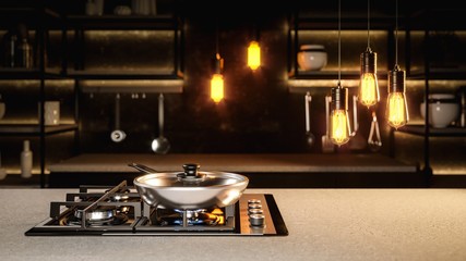 The new frying pan on the black glass cooking plate in the black loft interior with a Adison bulbs