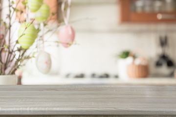 Obraz na płótnie Canvas Easter. Blurred kitchen and wooden tabletop with space for display your product.