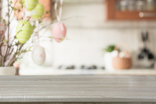 Easter. Blurred kitchen and wooden tabletop with space for display your product.