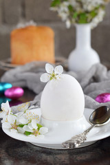 Obraz na płótnie Canvas White egg and flowers on clay plate. Happy Easter card. Holidays breakfast concept. Festive table place setting decoration with blossom, bunny, chocolate eggs.