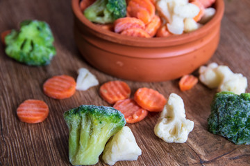 Homemade frozen organic vegetables in a ceramic bowl: cauliflower, Broccoli and carrot