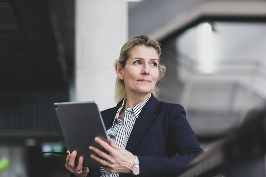Senior female business executive using digital tablet in a corporate office