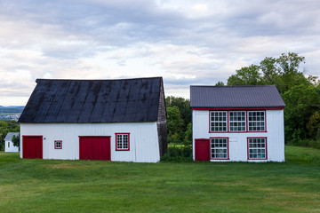 Old wooden red and white barn and hen house in the Island of Orleans, Quebec, Canada © Anne Richard