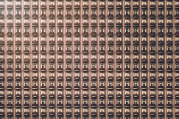 architectural pattern, dark facade with windows and red round balconies