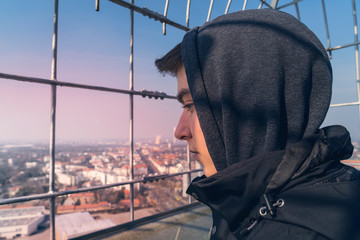 portrait of a young man on an observation tower