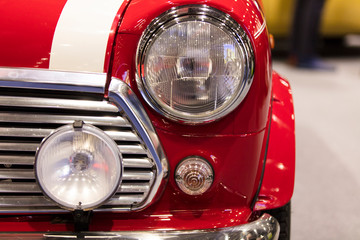 A close up of a classic vintage car headlight