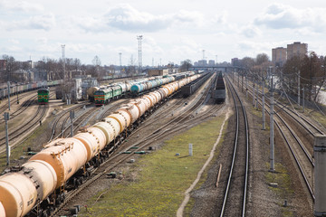 Railway with cargo locomotive with wagons. Many iron ways and trains. Freight train. 2018.