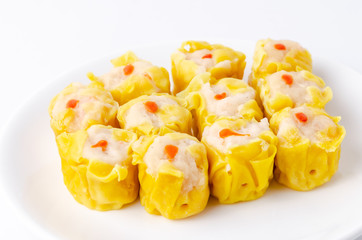 Chinese steamed shrimp dumplings on white dish