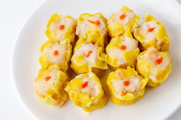 Chinese steamed shrimp dumplings on white dish