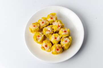 Chinese steamed shrimp dumplings on white dish