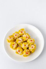 Chinese steamed shrimp dumplings on white dish