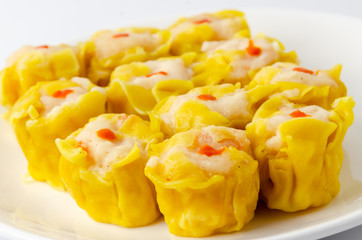 Chinese steamed shrimp dumplings on white dish