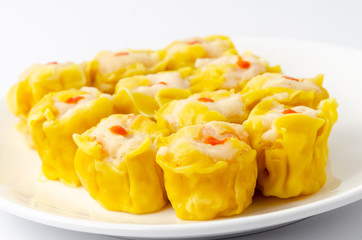 Chinese steamed shrimp dumplings on white dish