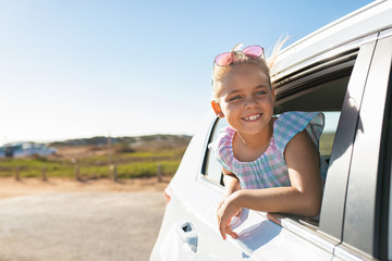 Cute girl looking out of car window