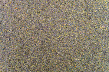 Textureof wet surface of the coating of bitumen roll roofing waterproofing with the sprinkling of...