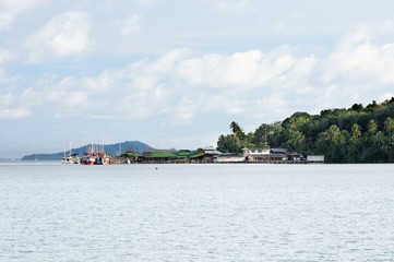 Fototapeta premium Fishing boats and yachts at the pier of the tropical Koh Chang island, Thailand.