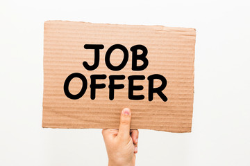 Hand holding a cardboard with the text : Job Offer, against white background