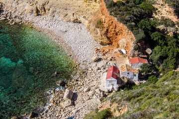 Llevant hidden cove beach in Benitatxell, Spain, with some fishermen houses
