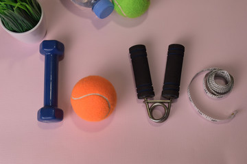 Naklejka premium Love fitness concept with dumbbells and water bottle. Workout inspiration
