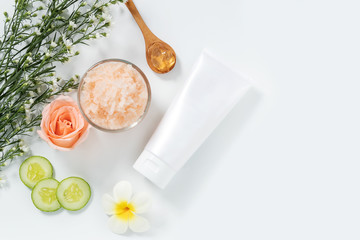 skin care concept. flat lays of skincare remedies style in white squeeze tube package with blank label and salt spa in glass bowl with natural materials isolated on white background