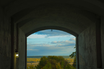Fototapeta premium arch of an old house on the background of a Sunny landscape