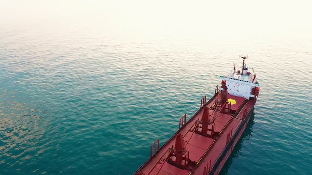 Large high-speed sea vessel for transporting a dry-cargo ship at high speed leaves the city sea port to open blue sea space. Import and export of goods by sea. Copyspace