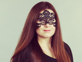 Mysterious woman wearing lace mask