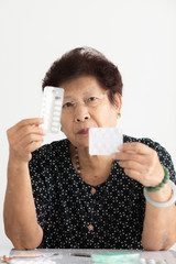 Asian senior woman showing medicines in her hands, lifestyle concept.