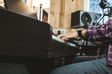 Detail of a hand playing a piano. Pianist concept