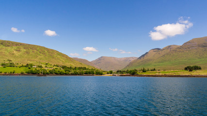 Irish landscape at the shore of Killary Harbour with beautiful green rolling hills and scattered...