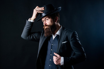 brutal caucasian hipster with moustache. Bearded man gentleman. Secret shy. Male formal fashion. Businessman in suit. Detective in hat. Mature hipster with beard. Thoughtful gentleman