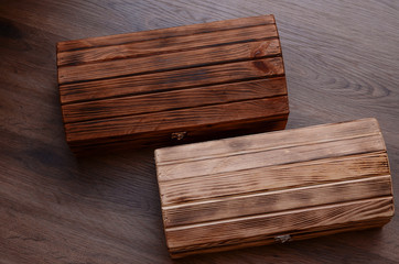 Two wooden luxury gift boxes or caskets on wood background. Wood texture