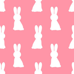 White Easter bunnies on pink background.