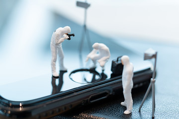 Miniature people : Police And Detective are working on smartphone , Crime scene investigation ,...