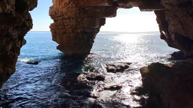 Cova dels Arcs cave, at Moraig cove beach, in Benitatxell, Alicante, Spain