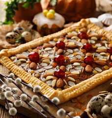 Mazurek pastry, traditional Polish Easter cake made of shortcrust pastry,  fudge caramel cream, candied fruit and almonds, close up. Easter treat