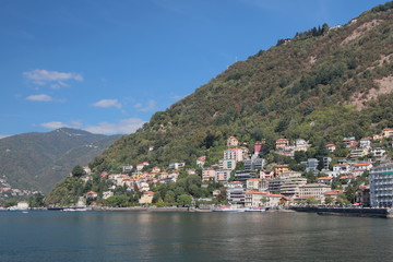 City on coast of lake in mountains. Como, Italy