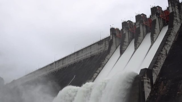 Dam with floodgate, Dam with water overflow, Spillway on the Khun Dan Prakan Chon Dam in Thailand.	