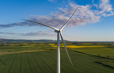 photos of wind turbines providing renewable green energy in england in the country side