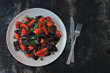 Healthy warm salad with baked beets, pumpkin and carrots. Vegan salad of warm vegetables.