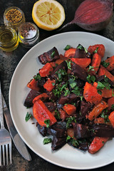Healthy warm salad with baked beets, pumpkin and carrots. Vegan salad of warm vegetables.